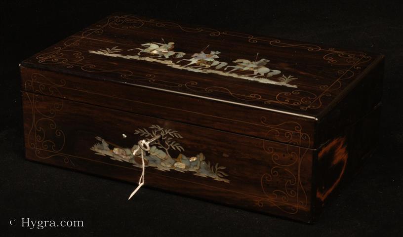 A mahogany writing box veneered in coromandel and inlaid in mother of pearl, abalone shell and brass and copper. The exotic horsemen are an unusual theme. The work is executed skillfully, utilizing the color and light values of the shells to create a sense of movement.The box is immaculately finished inside, and out, the coromandel facings are punctuated with mother of pearl dots. Quality work with a very smooth look which betrays dependence on mechanical processes. Mid 19th century. Enlarge Picture